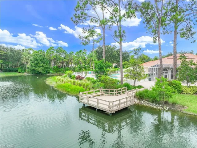 Dock area with a water view and a swimming pool