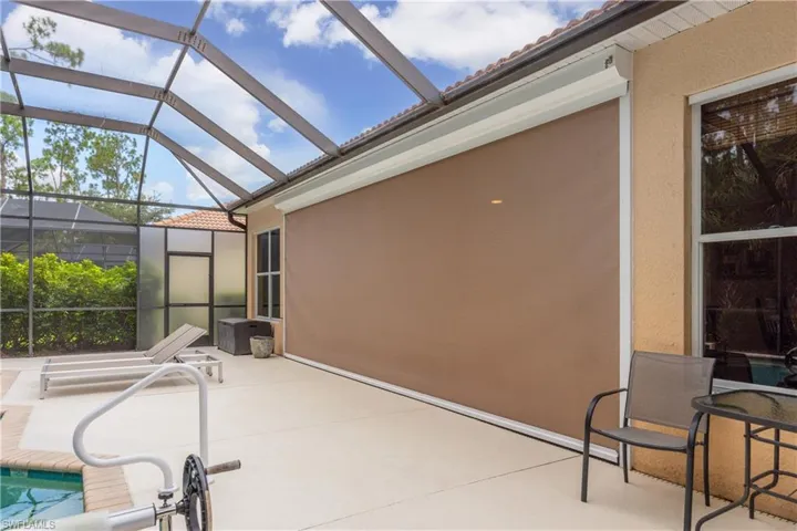 View of patio with a lanai with the hurricane shutter down