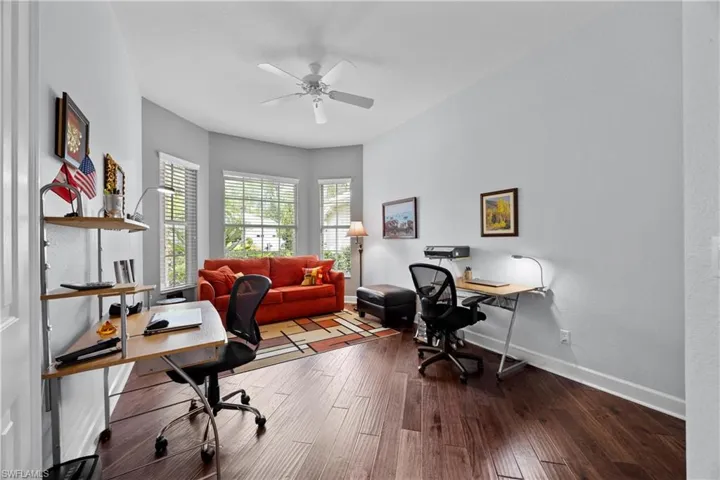 Home office featuring ceiling fan and wood-type flooring