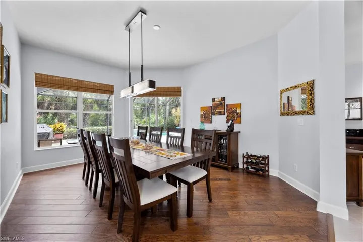 Dining area with dark hardwood / wood-style floors and plenty of natural light