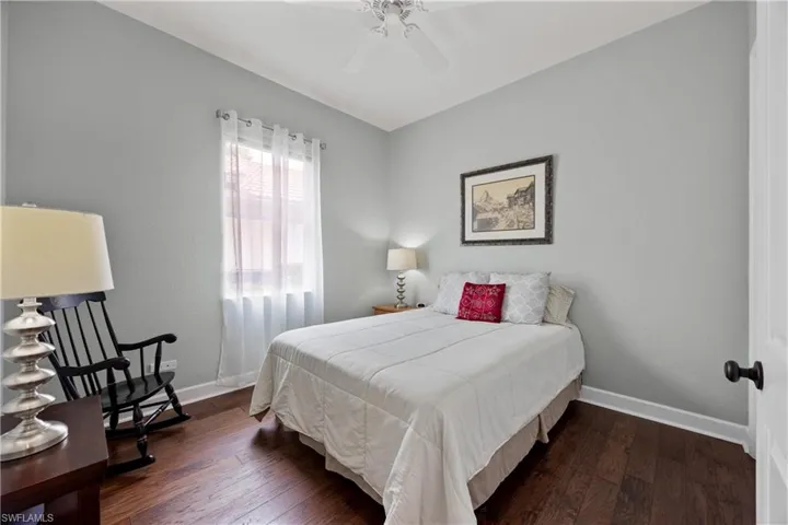 Bedroom featuring dark hardwood / wood-style floors and ceiling fan