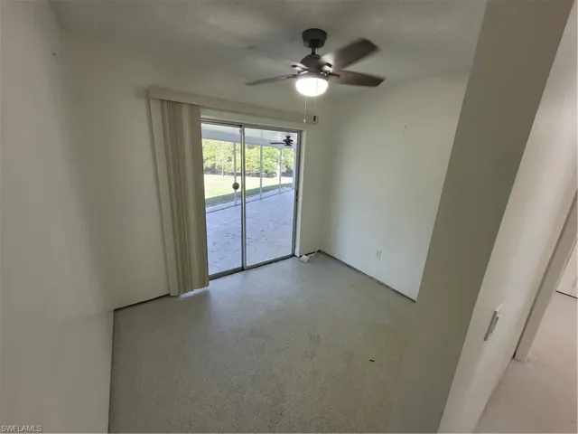 Unfurnished room featuring a ceiling fan and a textured ceiling