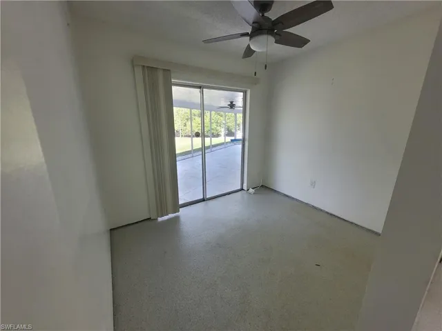 Empty room featuring a textured ceiling and speckled floor