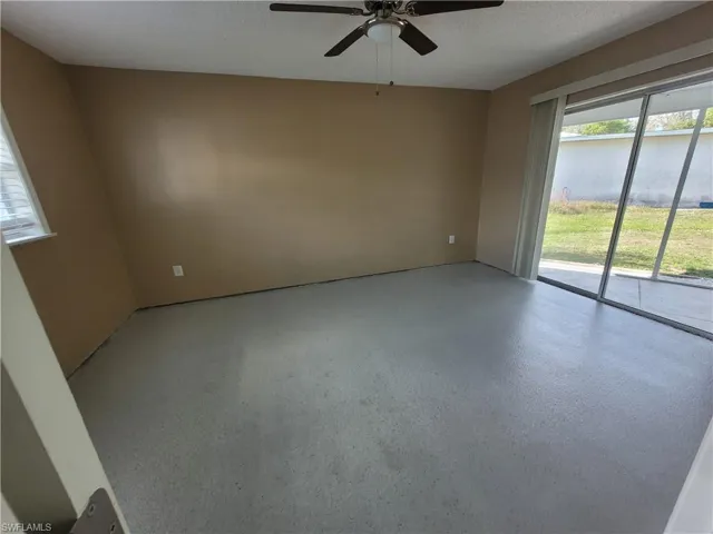 Unfurnished room featuring a textured ceiling and ceiling fan