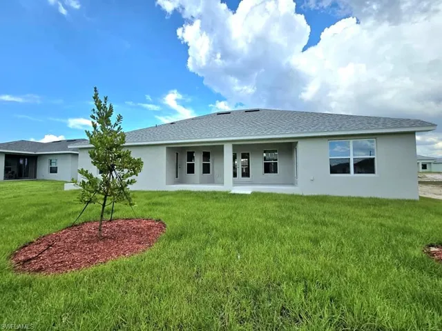 Rear view of house with a yard