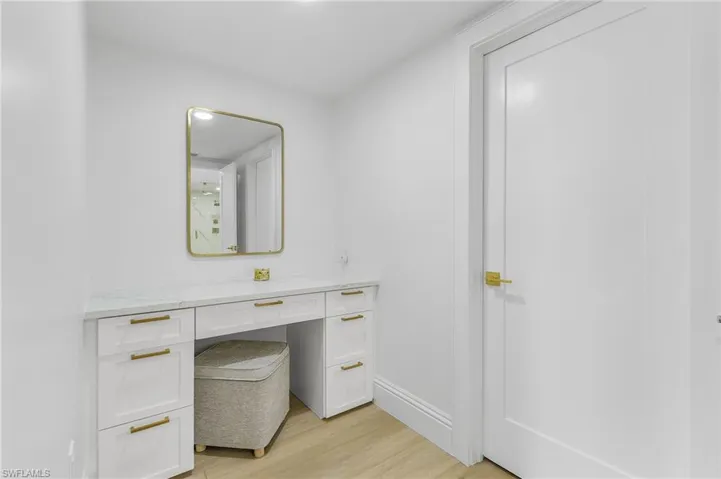 Bathroom with hardwood / wood-style flooring and vanity