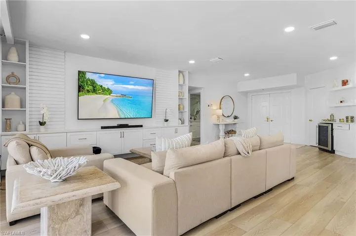 Living room featuring beverage cooler and light wood-type flooring