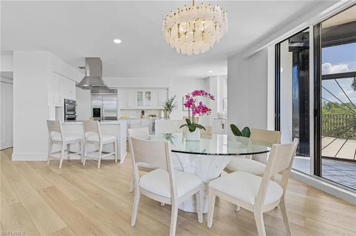 Dining room with light hardwood / wood-style floors and a chandelier