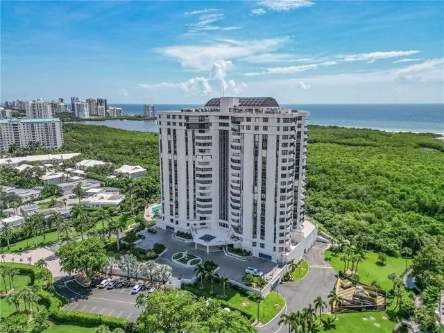 Birds eye view of property with a water view