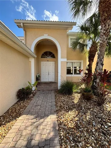 View of exterior entry with stucco siding