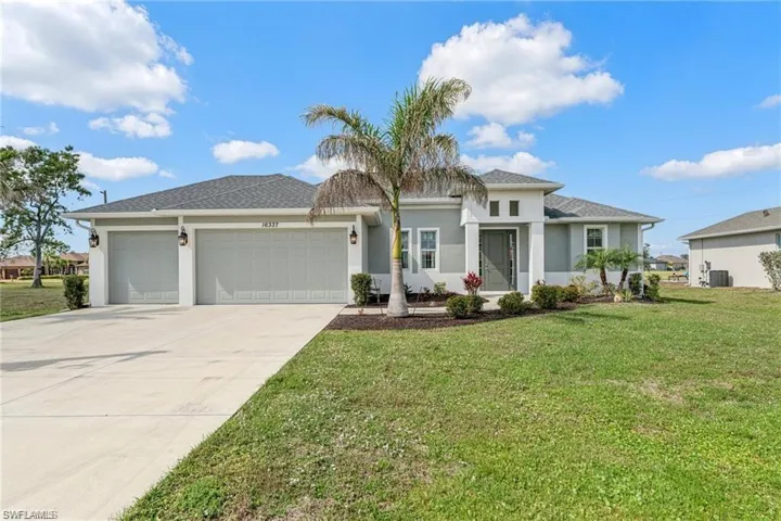 Prairie-style home featuring driveway, a front yard, a garage, and stucco siding