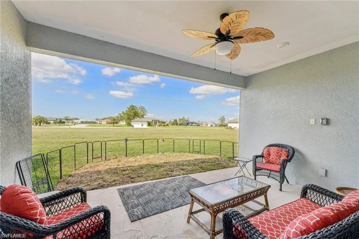 View of patio / terrace featuring fence, a rural view, and a ceiling fan