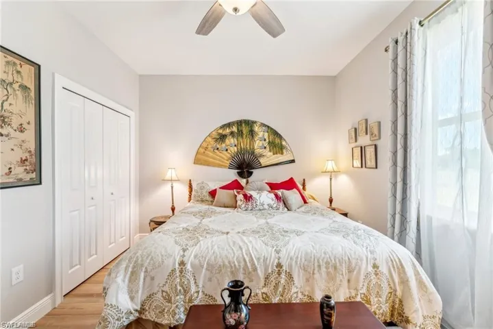 Bedroom with a ceiling fan, baseboards, a closet, and wood finished floors