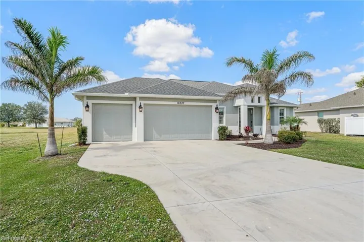 Ranch-style house with a front lawn, stucco siding, a garage, and concrete driveway