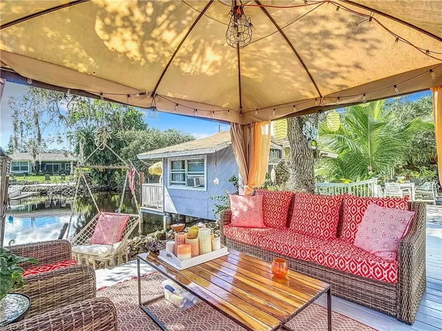 View of patio featuring a deck, an outdoor living space, and a gazebo