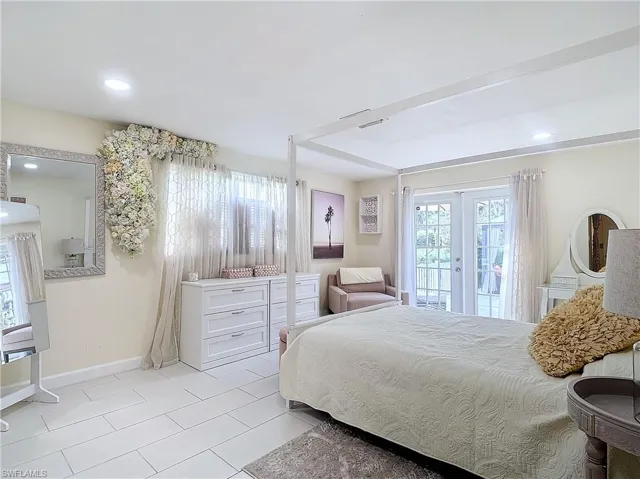 Tiled bedroom with access to exterior