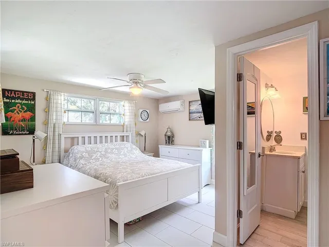 Bedroom with porcelian light wood-type flooring ensuite bathroom