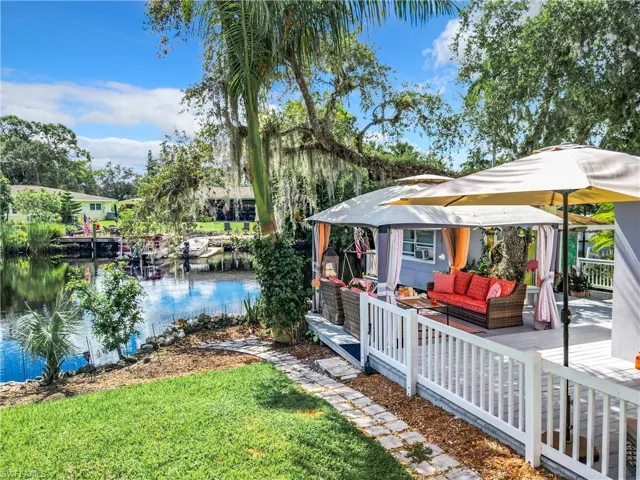 View of yard with outdoor lounge area, a patio, a gazebo, and a water view