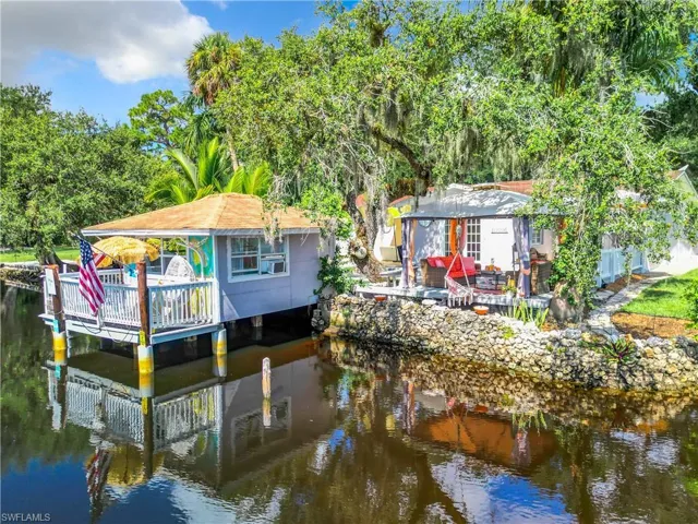 View of dock featuring a bungalow and a river view