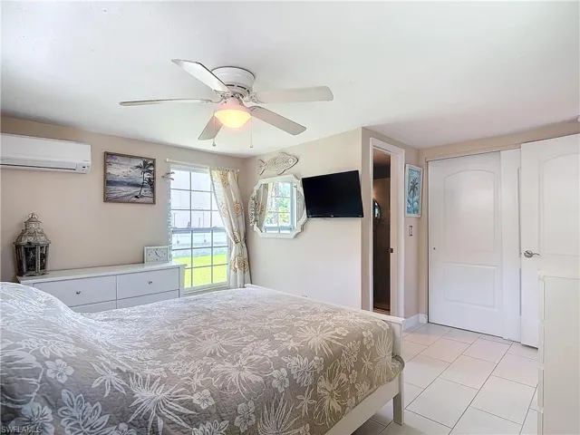 Bedroom with view of manicured lawn.