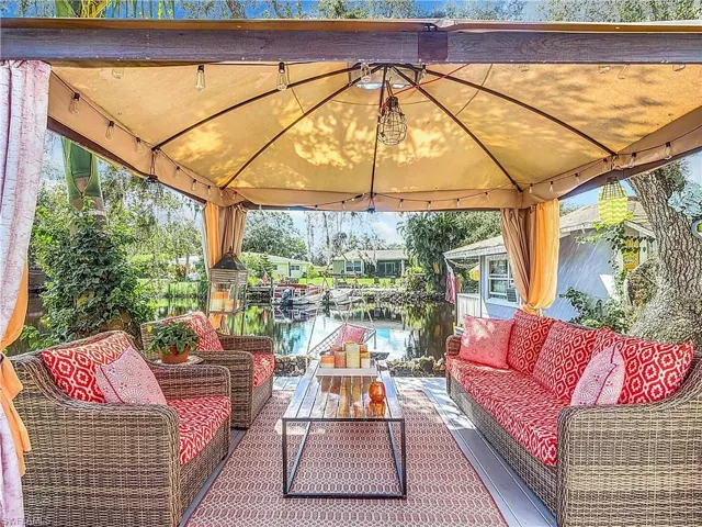 View of patio / terrace featuring an outdoor hangout area, a water view, and a gazebo