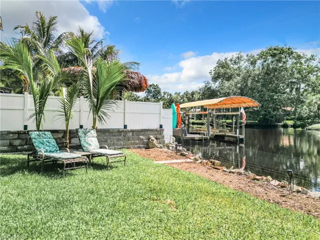 View of yard with a dock and a river view