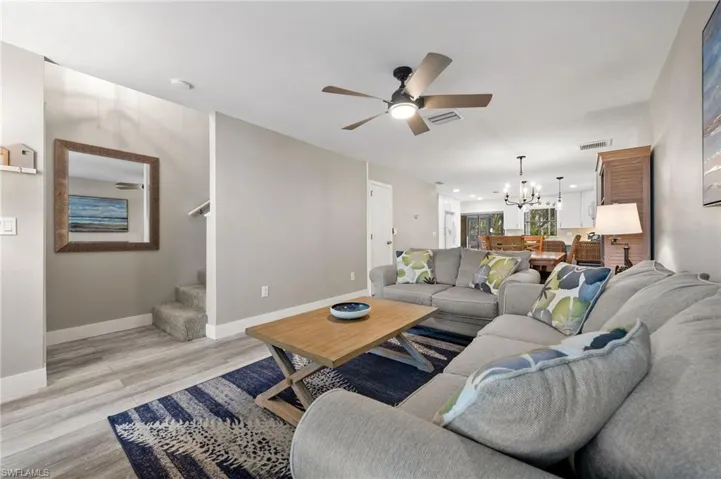 Living room with view to front door and stair to the upstairs.