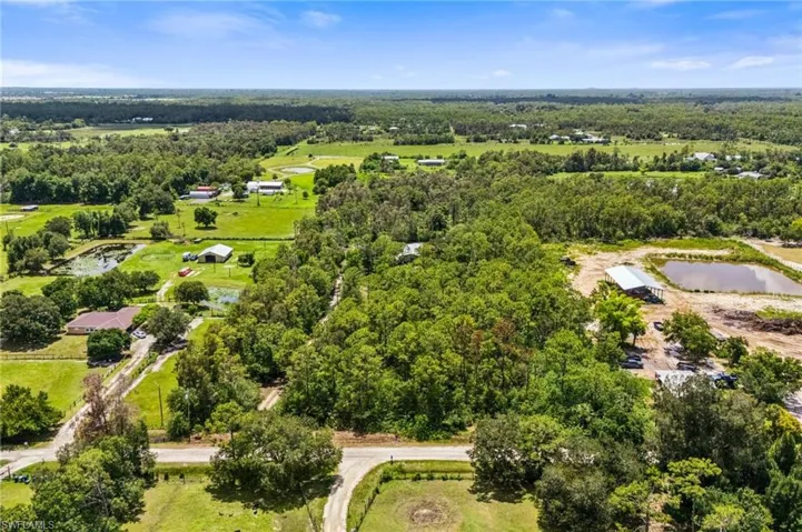 Bird's eye view of a nearby body of water and a heavily wooded area
