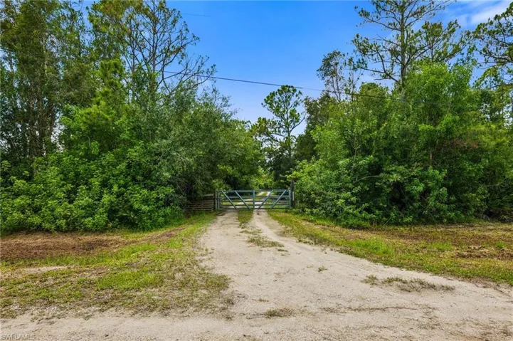 View of dirt / gravel road featuring a gate