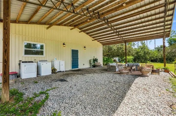 View of patio with washer and dryer and an outdoor living space