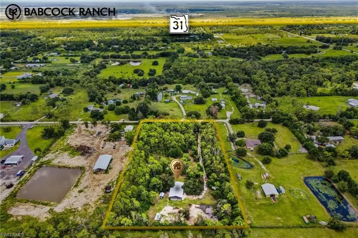 Aerial overview of property's location featuring property parcel outlined