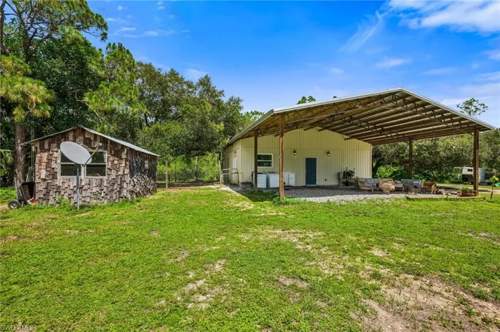 Rear view of house featuring an outdoor structure