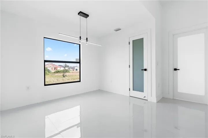 Unfurnished room with light tile patterned flooring