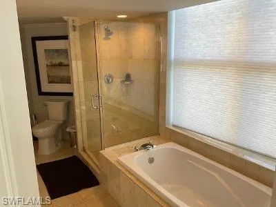 Full bathroom with a stall shower, a garden tub, and tile patterned floors