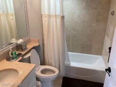 Bathroom with vanity and shower / bath combination with curtain