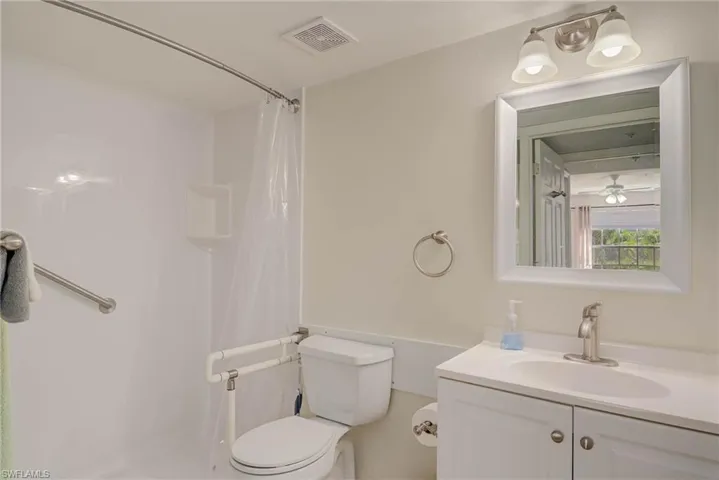 Bathroom with vanity and curtained shower
