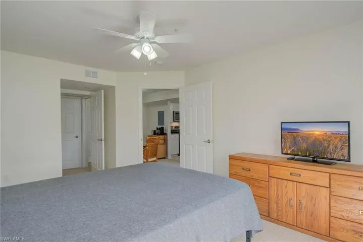 Bedroom featuring light carpet and a ceiling fan