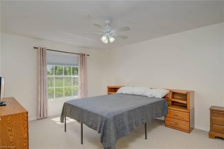Bedroom featuring light colored carpet and ceiling fan