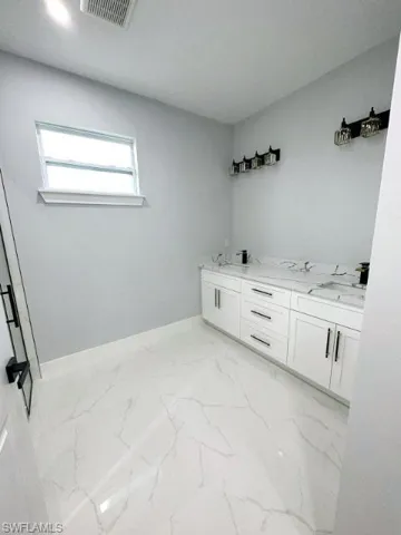 Bathroom with tile floors and double vanity