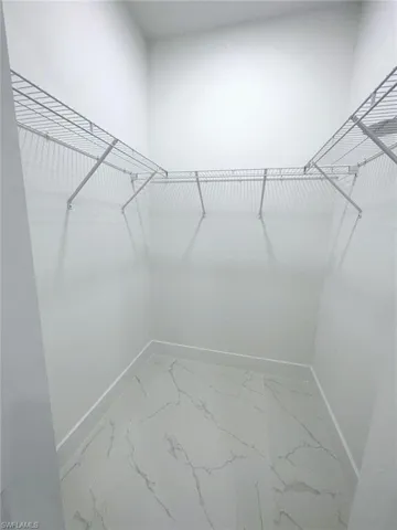 Walk in closet featuring tile flooring