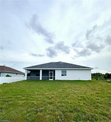 Rear view of house with a lawn