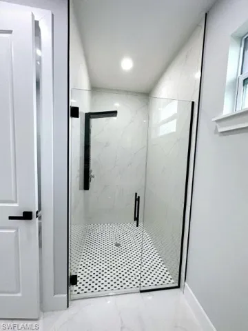 Bathroom featuring tile flooring and an enclosed shower