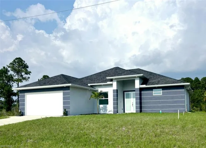 Prairie-style house with a garage and a front yard