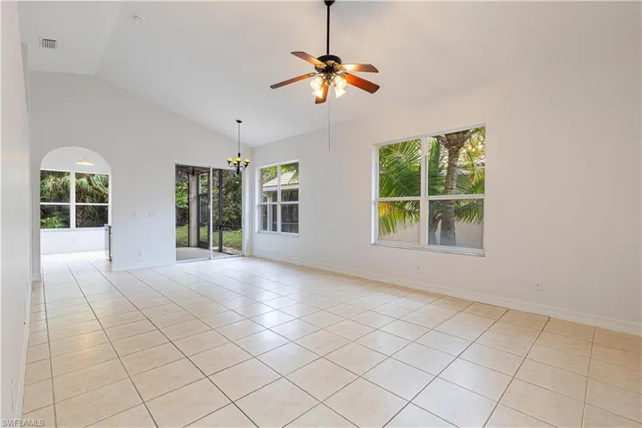 Open floor plan Diningroom / Livingroom featuring high vaulted ceiling