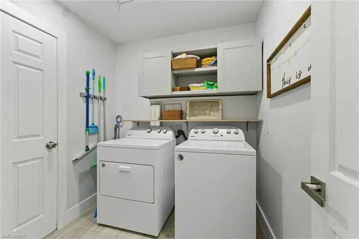 Washroom with cabinet space and separate washer and dryer