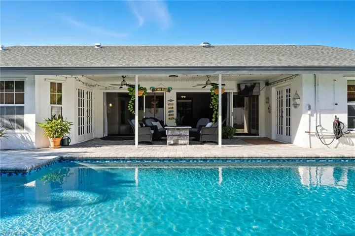 Outdoor pool with french doors, a patio, a ceiling fan, and outdoor lounge area