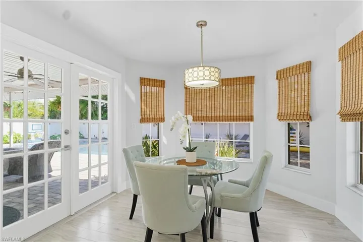 Dining room featuring french doors and light wood-style flooring