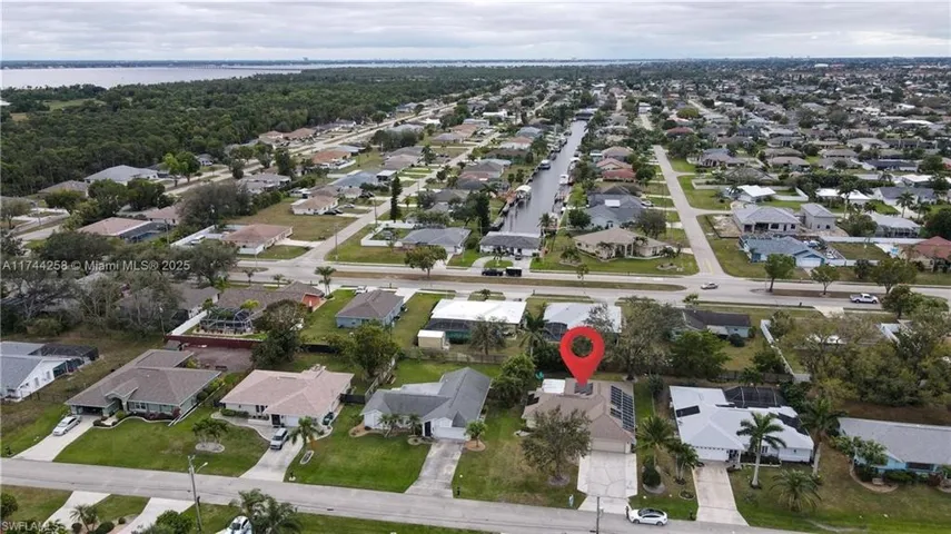 Aerial overview of property's location featuring nearby suburban area
