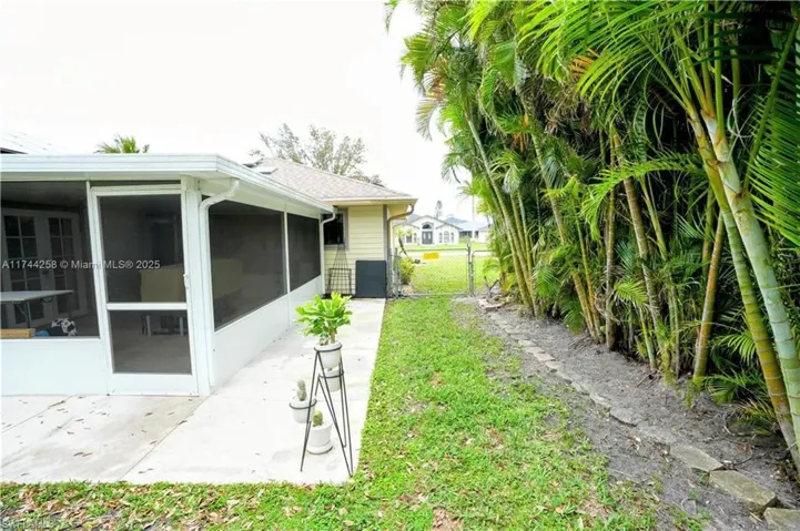 View of yard featuring a gate and a sunroom