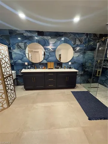 Bathroom featuring vanity and a shower with shower door